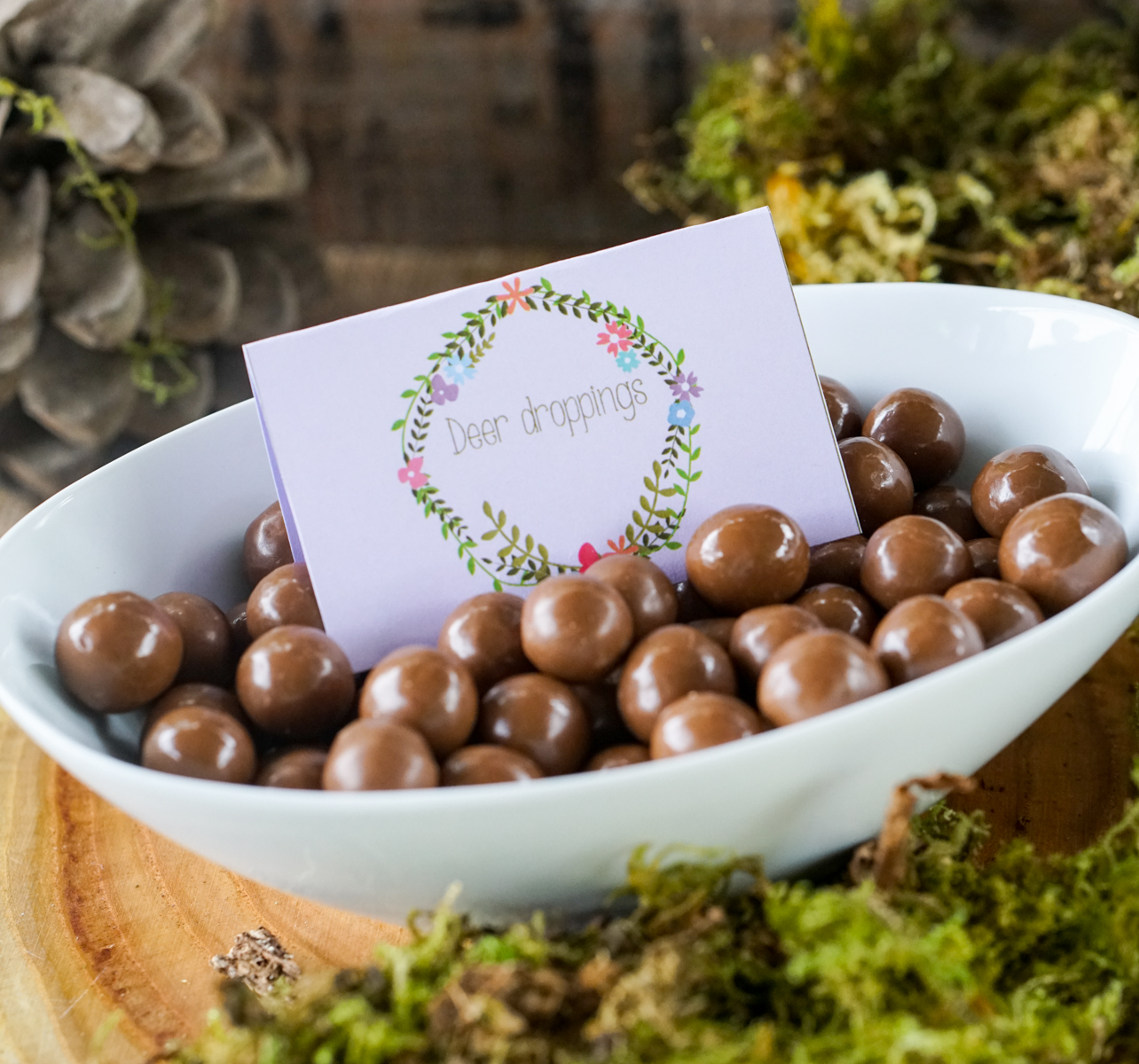 Boho Enchanted Forest Party Food Ideas of chocolate balls as Deer Droppings with a floral wreath food label