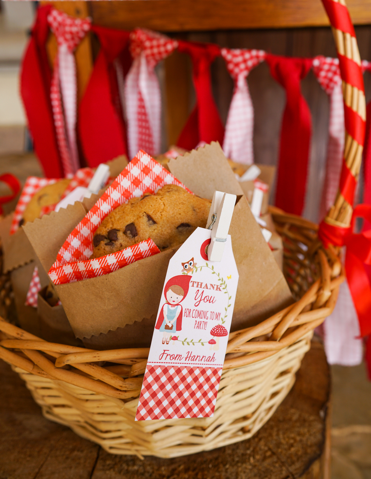 Little Red Riding Hood Party Favor Idea of a giant chocolate cookie placed in a brown bag with a printable thank you tag placed on with a peg