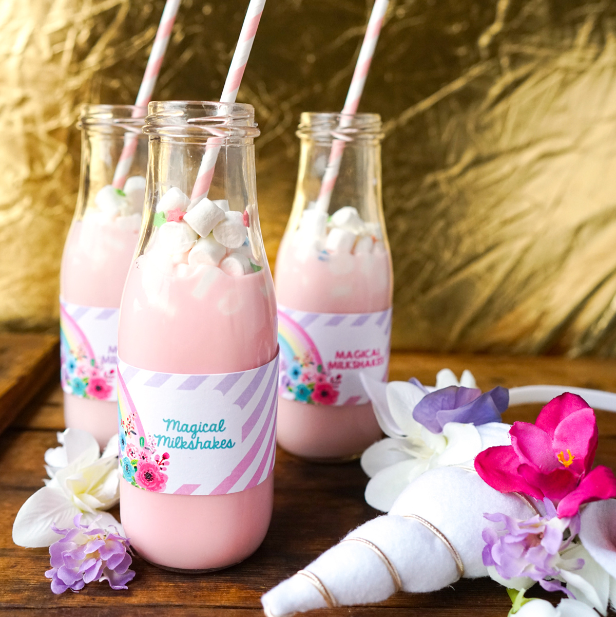 Pastel unicorn milkshakes in soft pink with editable bottle labels.