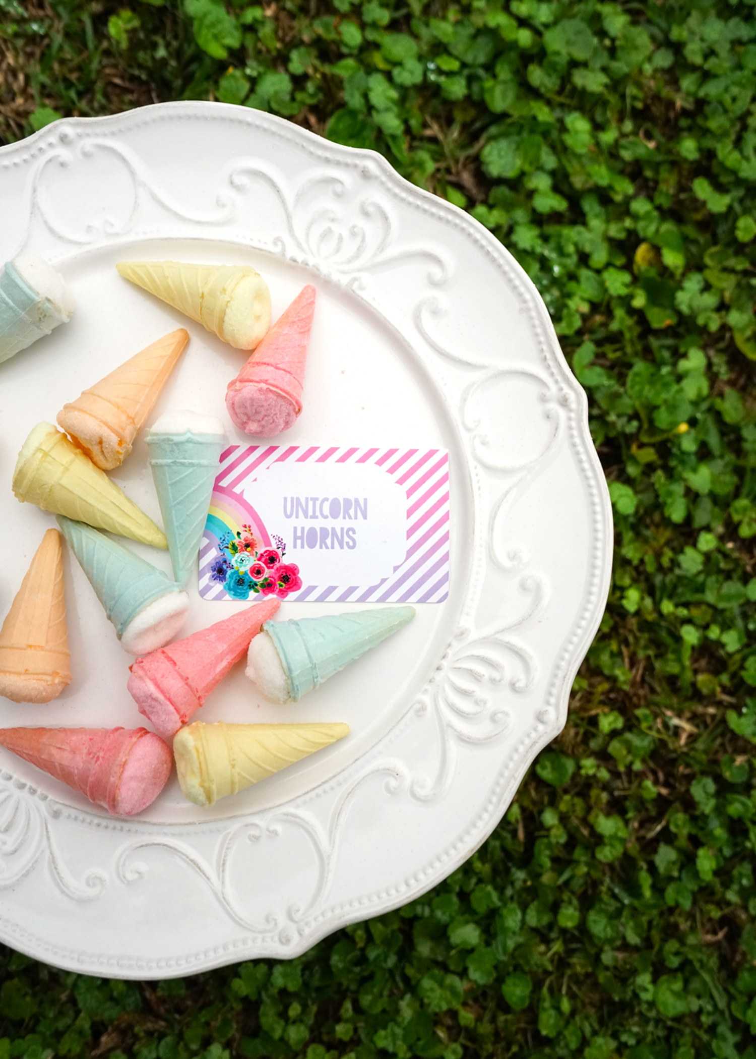Mini marshmallow ice cream cones with a food label 'Unicorn Horns' for a unicorn party food plate!