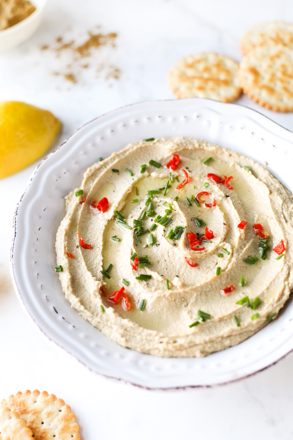 Hummus sprinkled with herbs and chilli